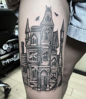 Get a unique blackwork tattoo of a grand castle or building on your upper leg by artist Rico Dionichi. Express your love for architecture with this detailed design.
