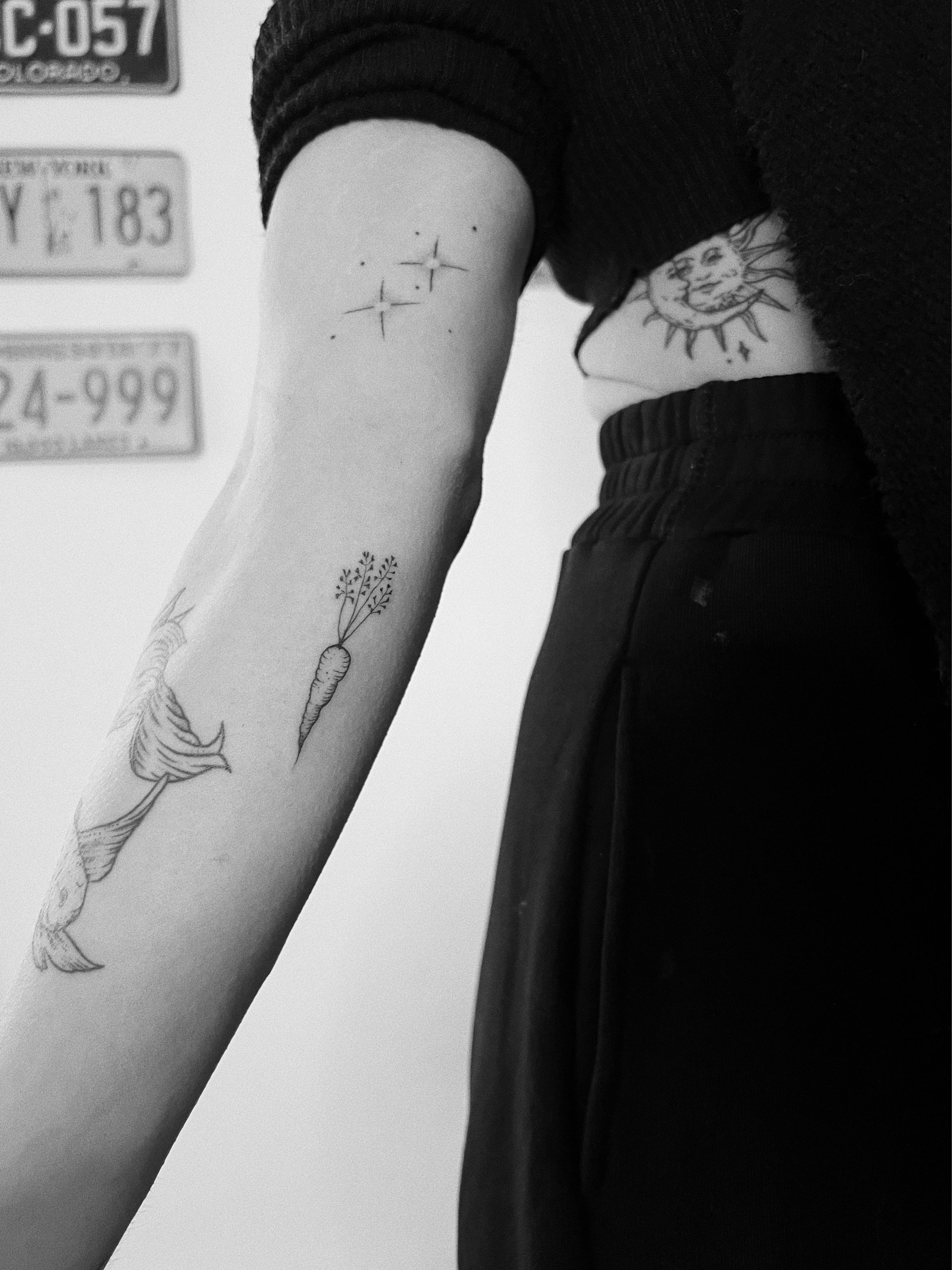a tattoo of Two Rabbits sharing a Carrot