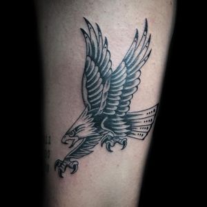 Impressive blackwork eagle tattoo on forearm by Chris Tambo. Detailed and powerful design.