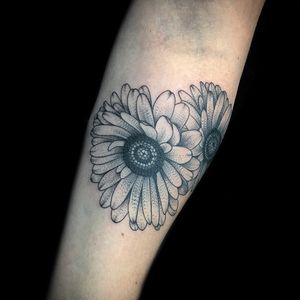 Unique blackwork forearm tattoo featuring a beautifully detailed flower by tattoo artist Chris Tambo.