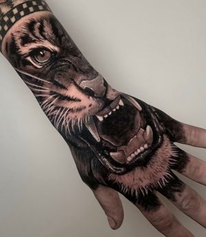 Tiger roaring hand tattoo