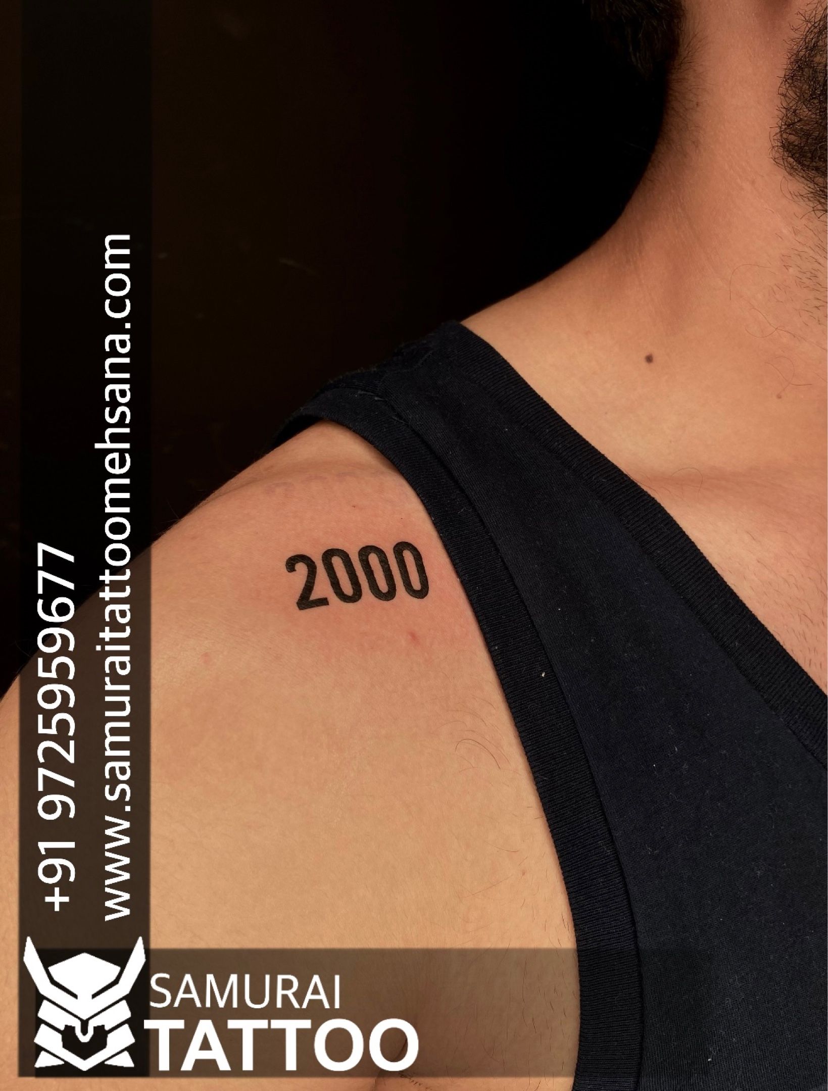 2000 lettering tattoo on the tricep