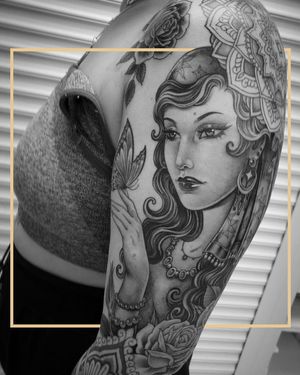 Get a chicano-style new school tattoo of a powerful woman on your upper arm in London. Stand out with this bold and unique design.