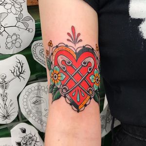 Get a vibrant and detailed neo-traditional floral heart design on your arm in London. Perfect for a bold and elegant look.