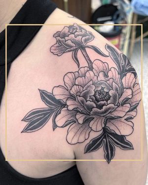 Get a stunning floral tattoo of a peony on your shoulder in London with a traditional style.