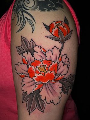 Neo-traditional masterpiece by Felipe Reinoso featuring a vibrant peony flower design on the upper arm.