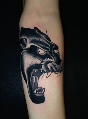 Get fierce with this bold blackwork panther tattoo by Felipe Reinoso. A classic design with a modern twist.