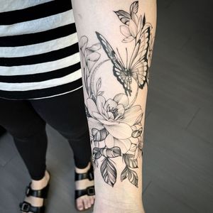 Beautiful blackwork and dotwork illustration of a butterfly and peony by Lawrence. Perfect for a bold forearm statement.