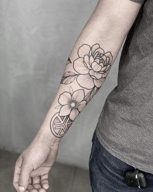 Get an elegant blackwork peony tattoo on your forearm by the talented artist Lawrence.
