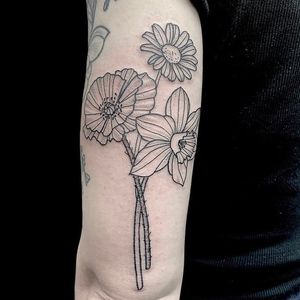 Get a beautiful floral tattoo on your upper arm in London. Embrace the beauty of nature with this delicate design.