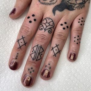 Get a delicate and intricate fine line flower and pattern tattoo on your finger in London for a unique and elegant look.