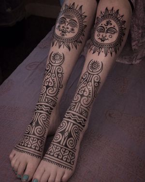 Get a unique tribal design featuring a sun and mandala on your foot in London, GB. Stand out with this intricate and meaningful tattoo.