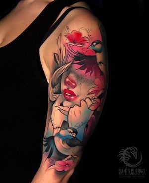 Vibrant new school tattoo featuring a beautiful woman, bird, and flower on upper arm. Located in London, GB.