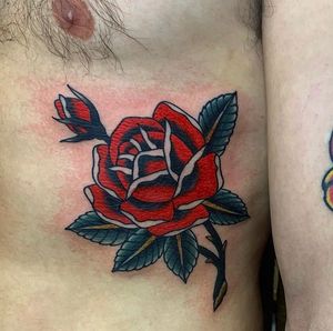 Get a beautiful illustrative flower tattoo on your ribs in London, GB. Traditional style with a modern twist.