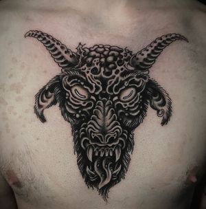 Get a fierce and captivating Japanese-inspired tattoo of a goat with devil horns on your chest in London, GB.