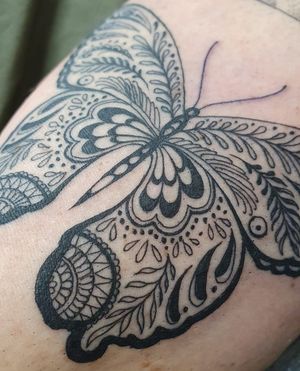 Elegant ornamental butterfly tattoo beautifully inked on the arm in London, GB. Perfect combination of style and symbolism.