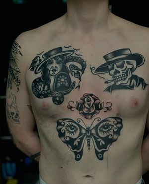 Get a stunning traditional tattoo on your chest in London featuring a butterfly, skull, and woman design.