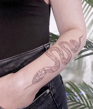 Get a bold blackwork snake design on your forearm in the heart of Los Angeles for a unique illustrative look.