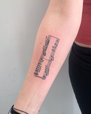 Illustrative fine line tattoo on forearm featuring music motif by Brigid Burke. Perfect for music lovers!