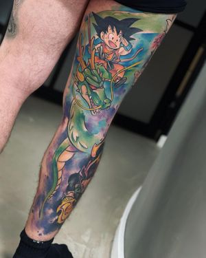 Get a bold new_school tattoo on your knee featuring a fierce dragon and the iconic goku by artist Artemis.
