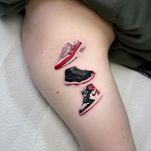 Get a stunning upper arm tattoo of your favorite sneakers by the talented artist Artemis. A perfect blend of realism and illustrative style.