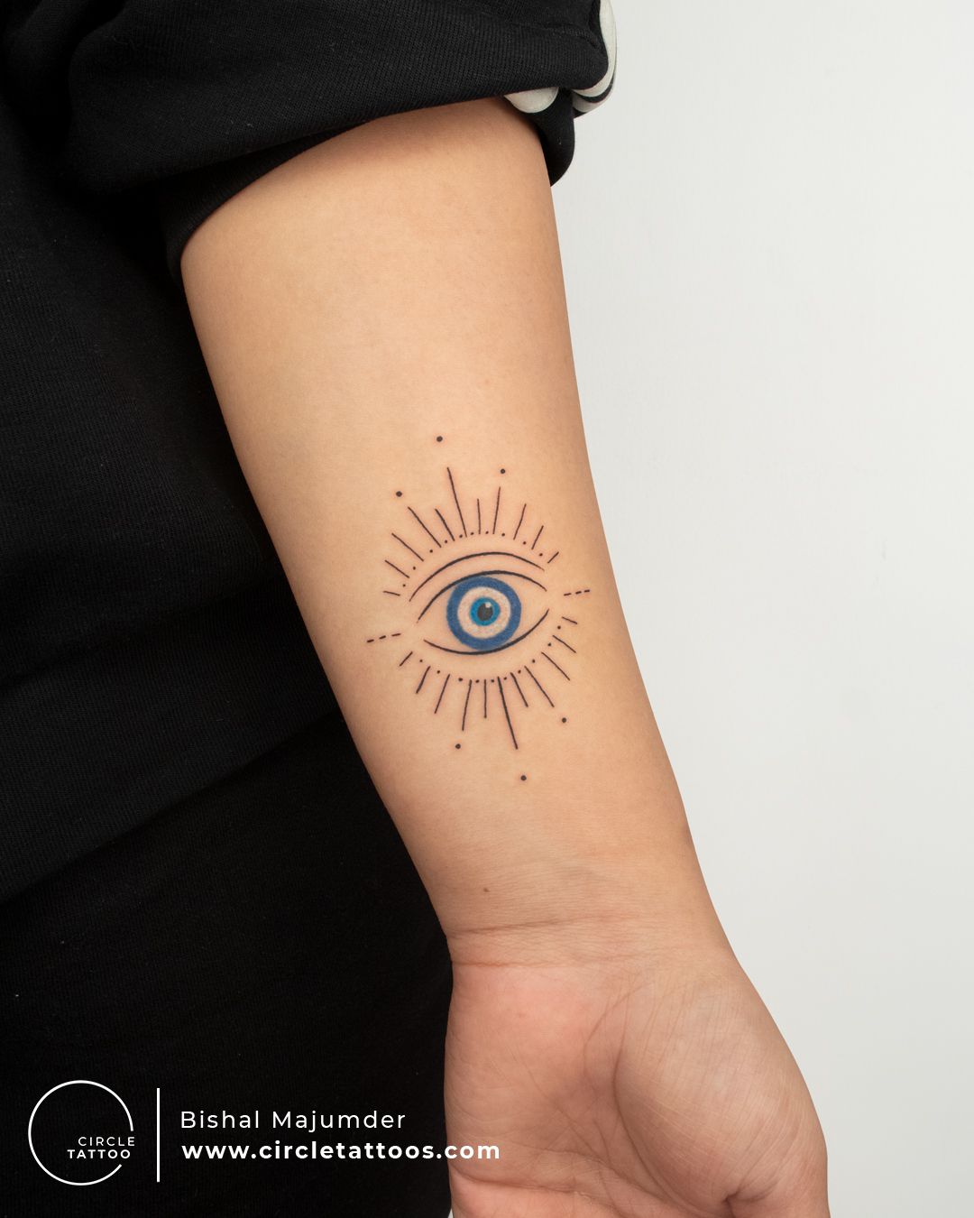 Evil eye tattoo located on the wrist minimalistic