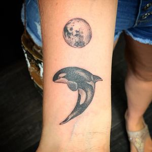 Experience the magic of a whale breaching under the moon in this blackwork forearm tattoo by Jose Cordova.