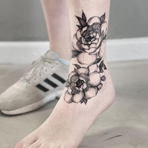 Get a stunning illustrative blackwork peony tattoo on your ankle in Los Angeles. Stand out with this beautiful floral design.