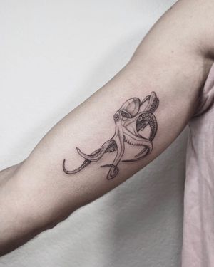 Get a beautifully detailed octopus tattoo on your upper arm in Los Angeles. This fine line, illustrative design will surely make a statement.