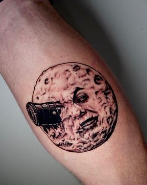Striking blackwork moon tattoo on lower leg by Miss Vampira, featuring intricate illustrative design.