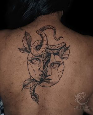 Capture the essence of London with this black-and-gray neo-traditional tattoo featuring a snake and mask on the upper back.