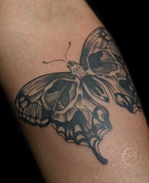 Capture the beauty of London with a black and gray butterfly tattoo elegantly inked on your arm.