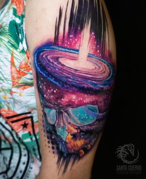 Experience the mesmerizing blend of watercolor galaxy and surreal skull by talented artist Alex Santo.