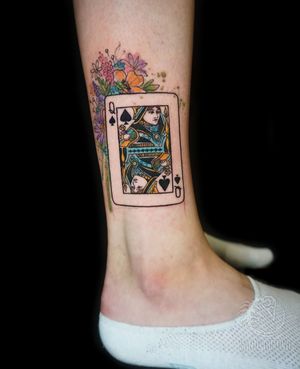 Get a unique illustrative tattoo on your lower leg in London, featuring a beautiful watercolor flower and card design.