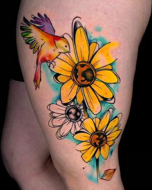 Embrace the beauty of nature with this colorful new school watercolor tattoo by Sandro Secchin, perfect for your upper arm.