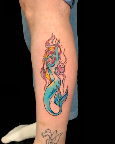Vibrant watercolor style mermaid tattoo on forearm by artist Sandro Secchin, perfect for those who love ocean and fantasy themes.