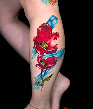 Get a stunning new school lower leg tattoo featuring a colorful flower motif by tattoo artist Sandro Secchin.