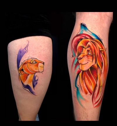 Vibrant new school tattoo by Sandro Secchin, featuring a fierce lion and lioness in a watercolor style on the lower leg.
