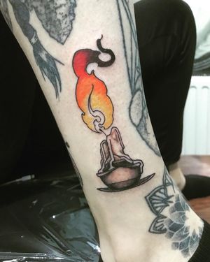 Get inked with this vibrant new school style candle tattoo by artist Frankie Brown. Perfect for adding a pop of color to your lower leg!