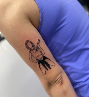 Get a bold blackwork woman tattoo on your upper arm by the talented artist Miss Vampira. Express your strength and beauty with this illustrative design.