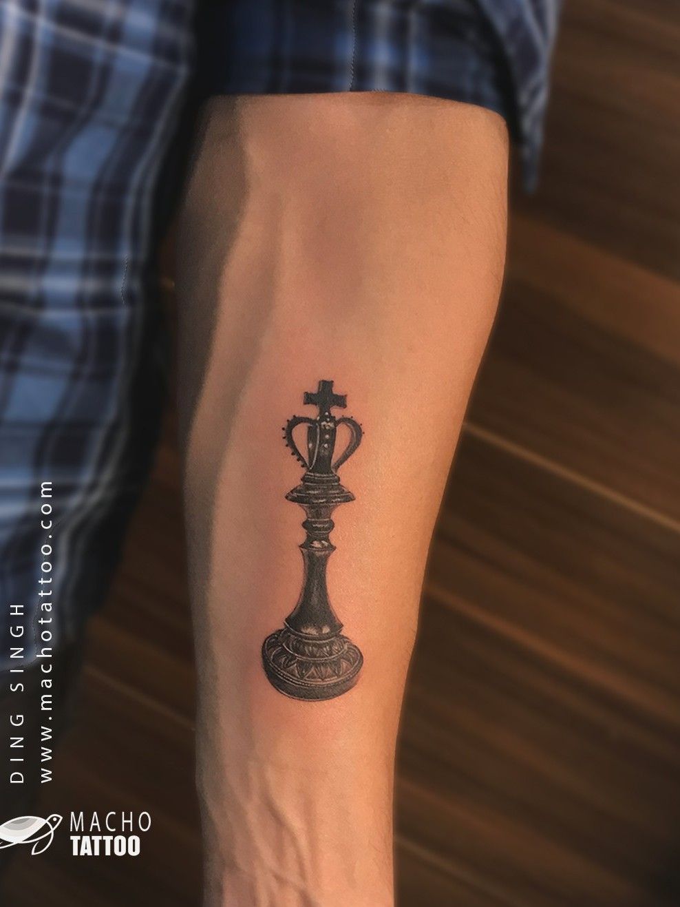 queen chess piece tattoo on wrist