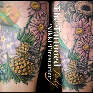 Fresh color in this leg sleeve addition I've been working on. The purple forget-me-not style flowers and the bird were preexisting. Pretty much everything else is mine. Here we have some pinecones, juniper berries, and a couple of daisies that got color. 🌼🌻🌲🌿....#tattoos #BodyArt #BodyMod #modification #ink #art #QueerArtist #QueerTattooist #MnArtist #MnTattoo #TattooArt #TattooDesign #TheTattooedLady #TattooedLadyMN #NikkiFirestarter #FirestarterTattoos #firestarter #MinnesotaTattoo #MNtattooers #DarkLab #FKiron #EternalInk #Saniderm #H2Ocean #daisy #pinecones #JuniperBerries #illustrative #ColorTattoo #NatureTattoo