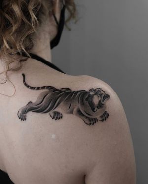 Get fierce with this blackwork tiger design by FKM Tattoo, combining traditional Japanese style with illustrative flair.