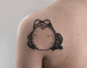 Get a stunning blackwork tattoo of a traditional Japanese frog design by FKM TATTOO on your shoulder.