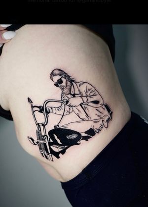Breathtaking blackwork piece by Miss Vampira featuring a man with glasses riding a motorcycle, beautifully illustrated on the ribs.