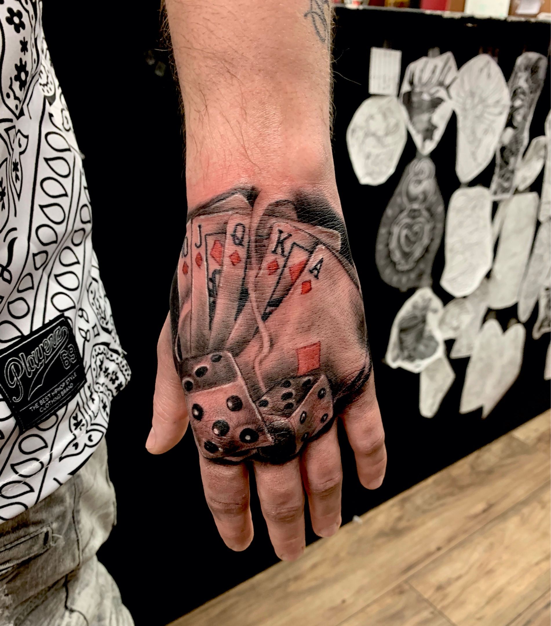 hand rolling dice tattoo