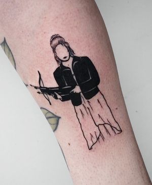 An edgy tattoo featuring an arrow, gun, woman, and bow in bold blackwork style by Miss Vampira.
