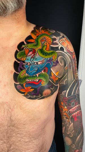 Beautifully detailed fish, flower, and hannya motifs in a traditional Japanese illustrative style.