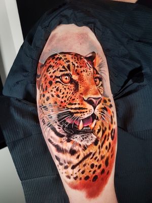 Get a fierce and lifelike leopard tattoo on your upper arm by talented artist Marie Terry. Embrace your wild side with this stunning piece of body art.