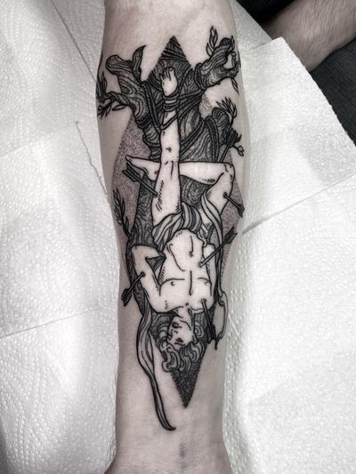 A stunning black and gray tattoo featuring a tree, arrow, man, and rope design by the talented artist Lamat.